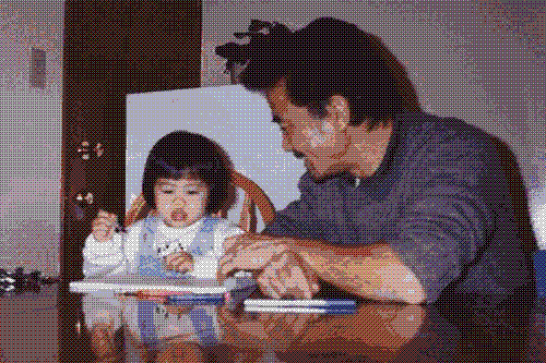 Me as a toddler drawing with my dad